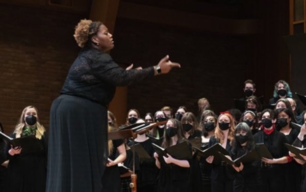 Woman directing student choir