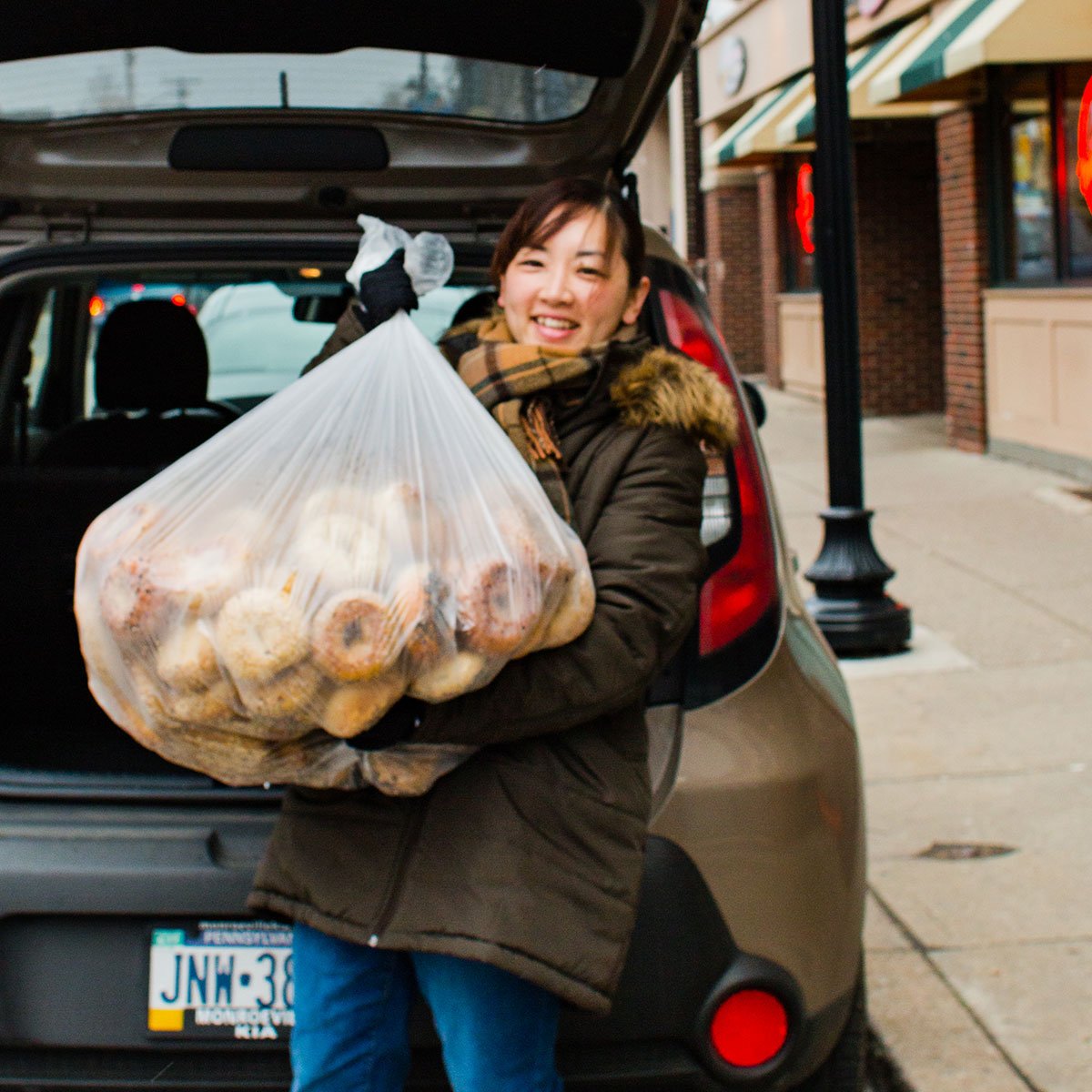 Lady with a bag of bagels